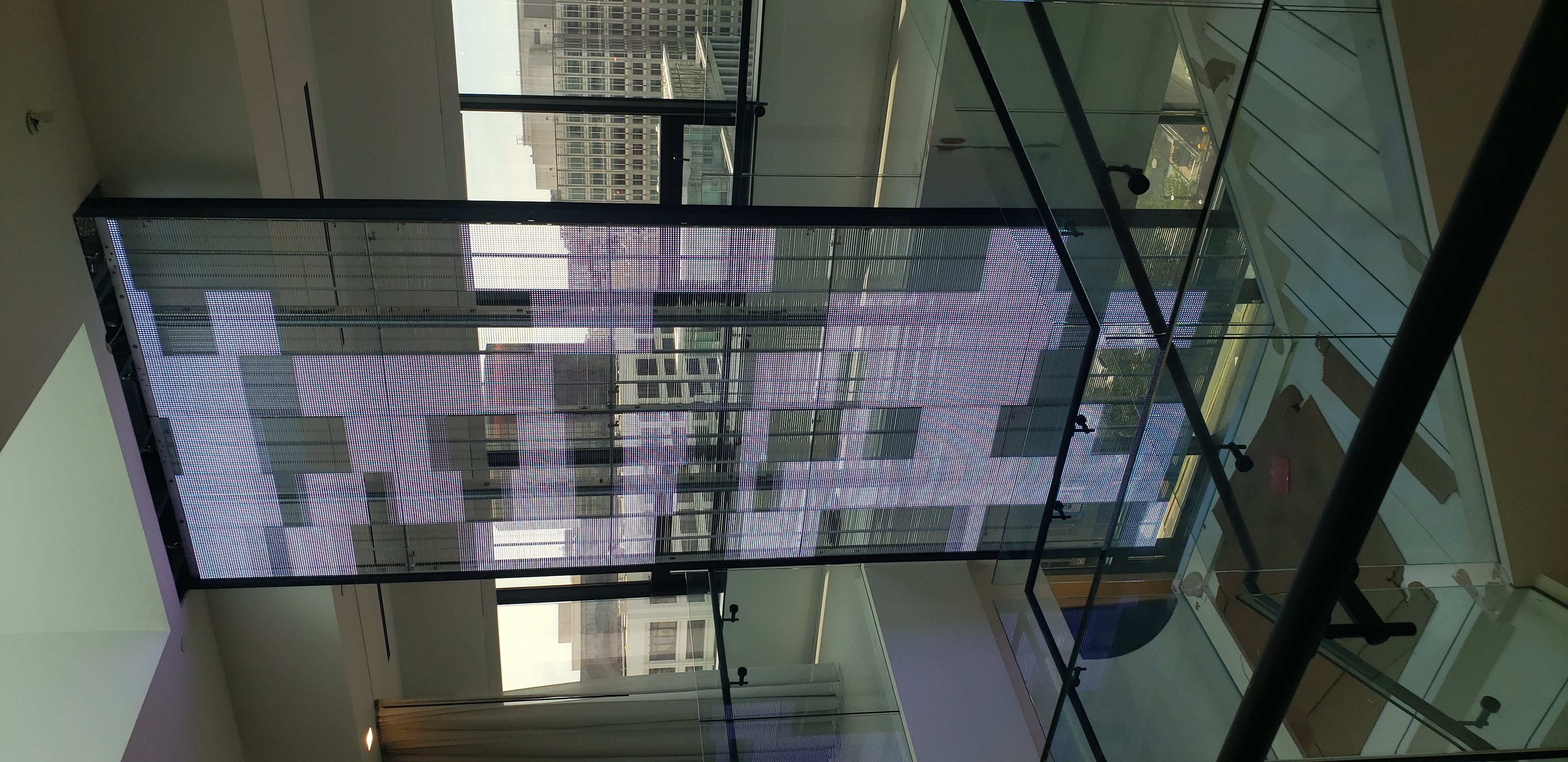 Large LED display installation in a glass lobby environment